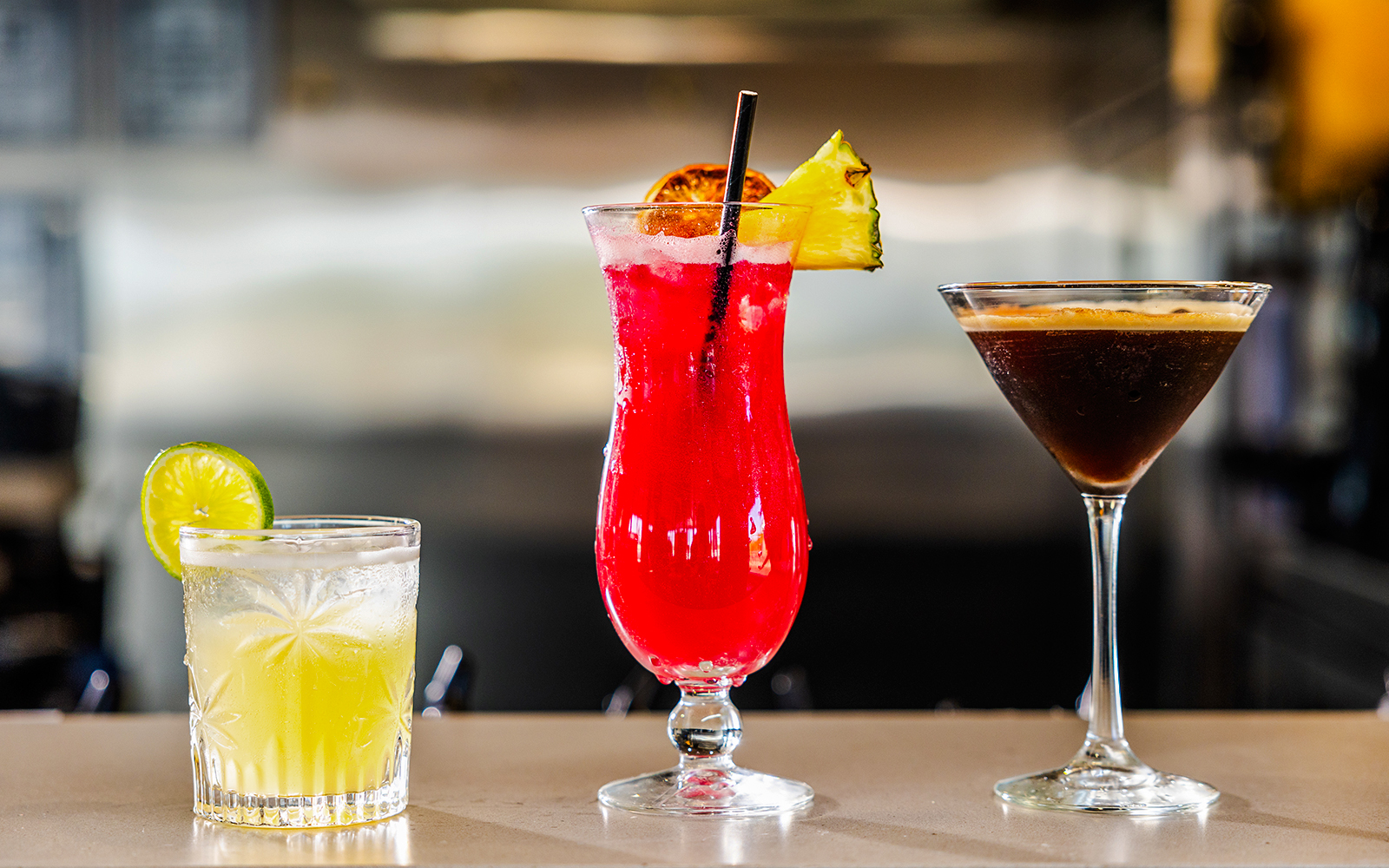 Cocktails on bar at Gold Coast buffet lunch, featuring lime, pineapple, and espresso drinks.