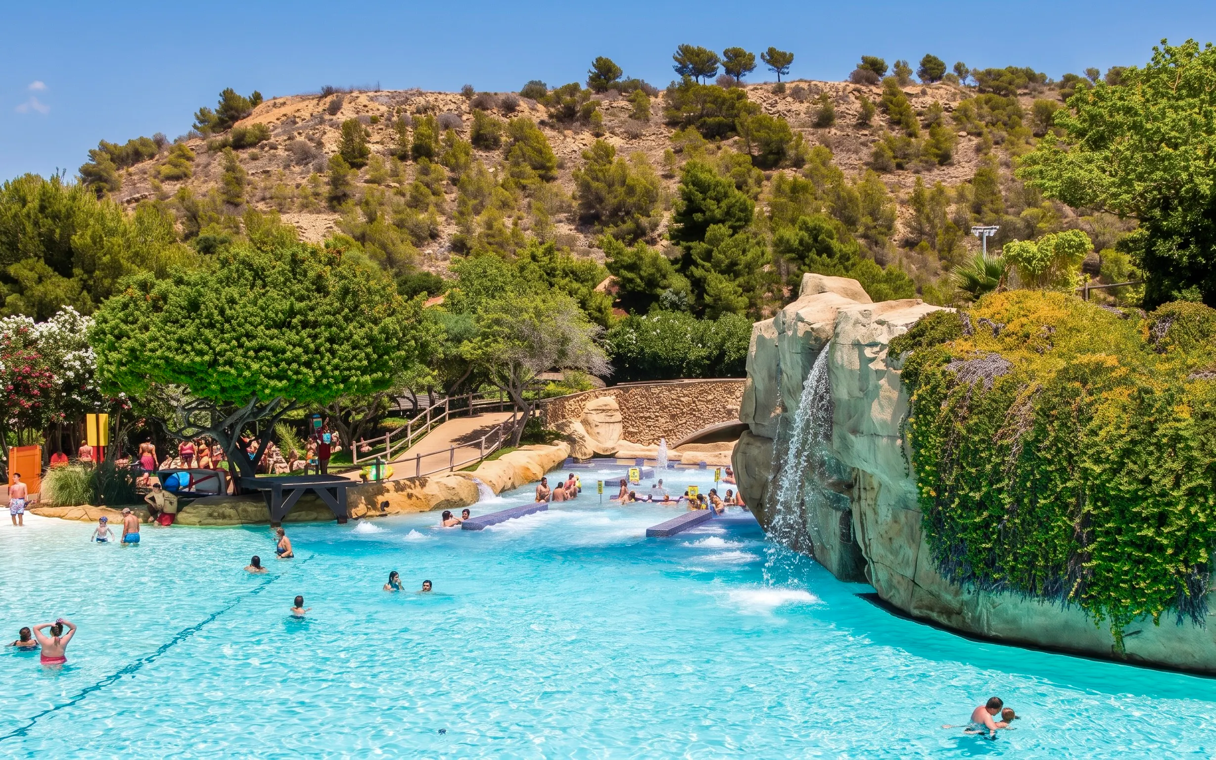 Visitors enjoying the Jacuzzi area at Aqualandia Benidorm, Spain, with a waterfall feature.