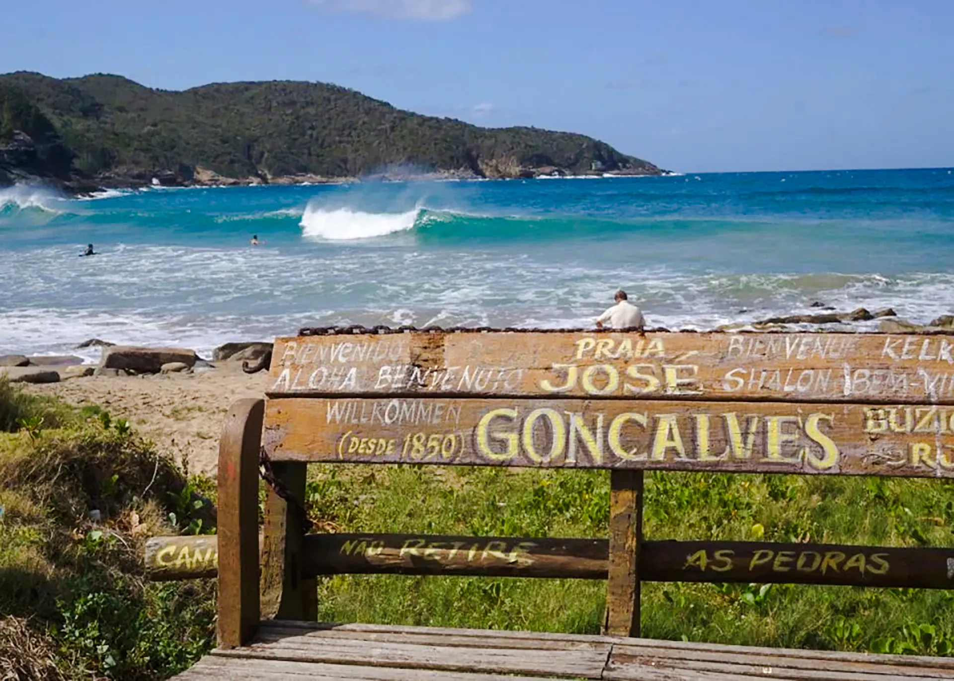 Bench overlooking Praia José Gonçalves beach with waves in Búzios, Rio de Janeiro.