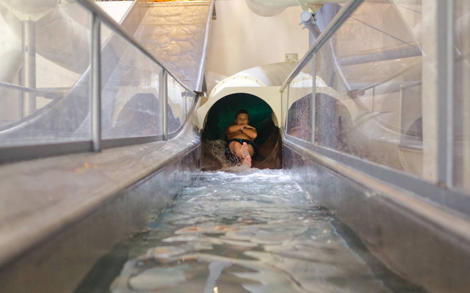 Person sliding down Saturn slide in Galaxy Zone at Therme Bucharest.