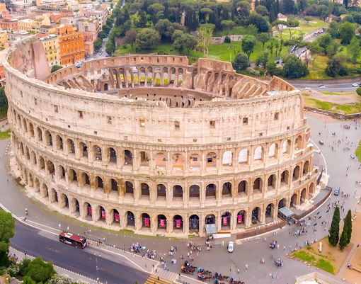 Aerial view of the Colosseum in Rome with surrounding cityscape.