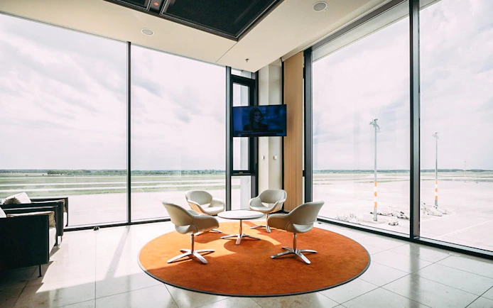 Seating area with runway view at BER Lounge Tempelhof, Berlin Brandenburg Airport Terminal 1.