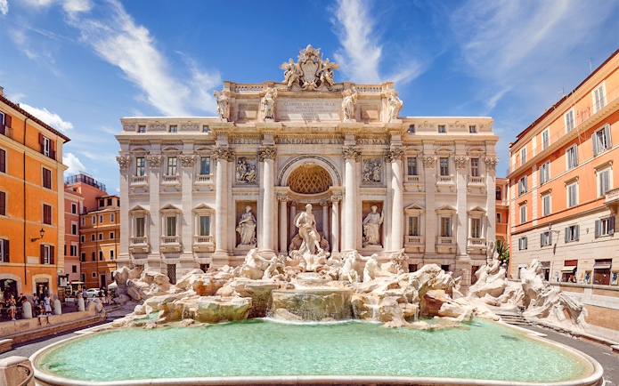 Trevi Fountain in Rome with baroque sculptures and turquoise water.