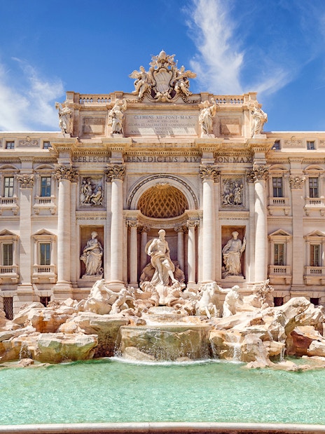 Trevi Fountain in Rome with baroque sculptures and turquoise water.