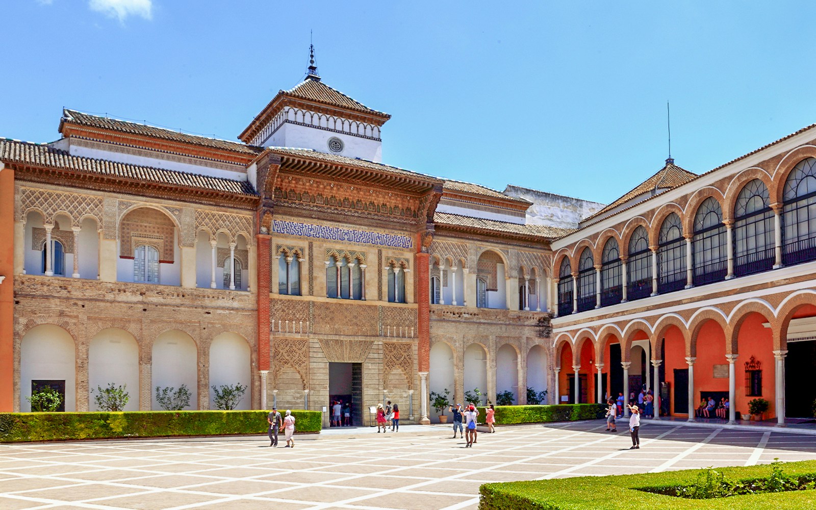 Tour guide leading a group through the ornate archways of Alcazar of Seville on a Skip-the-Line Guided Tour in Seville, Spain