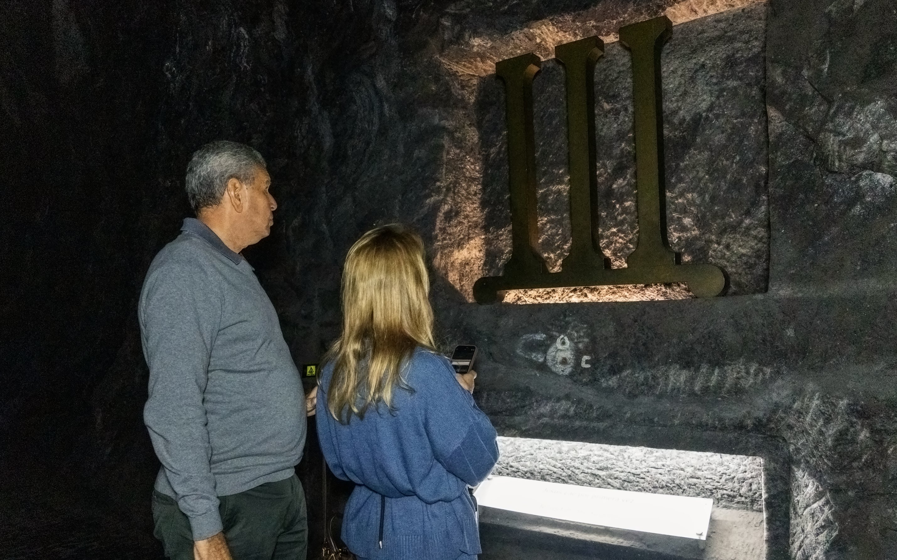 Tourists observing a station of the cross inside Zipaquira Salt Cathedral.