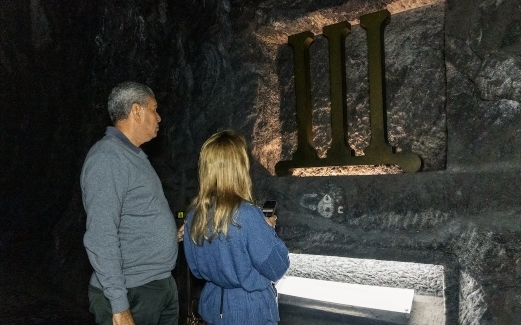 Tourists observing a station of the cross inside Zipaquira Salt Cathedral.
