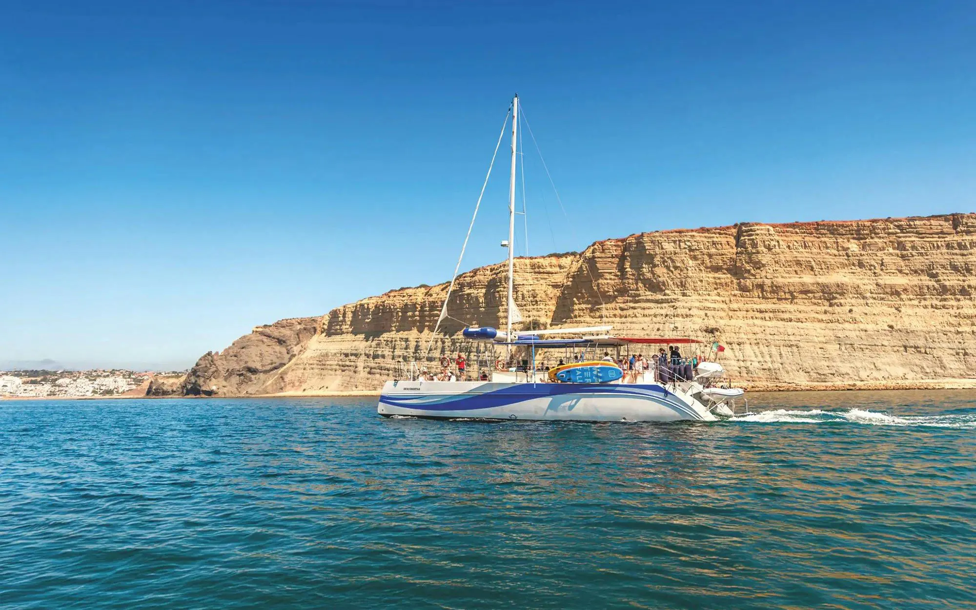 Catamaran cruising near Ponta da Piedade cliffs, Lagos.