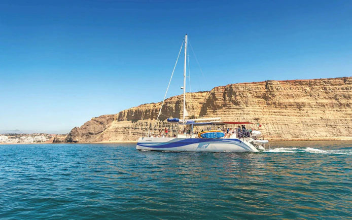 Catamaran cruising near Ponta da Piedade cliffs, Lagos.
