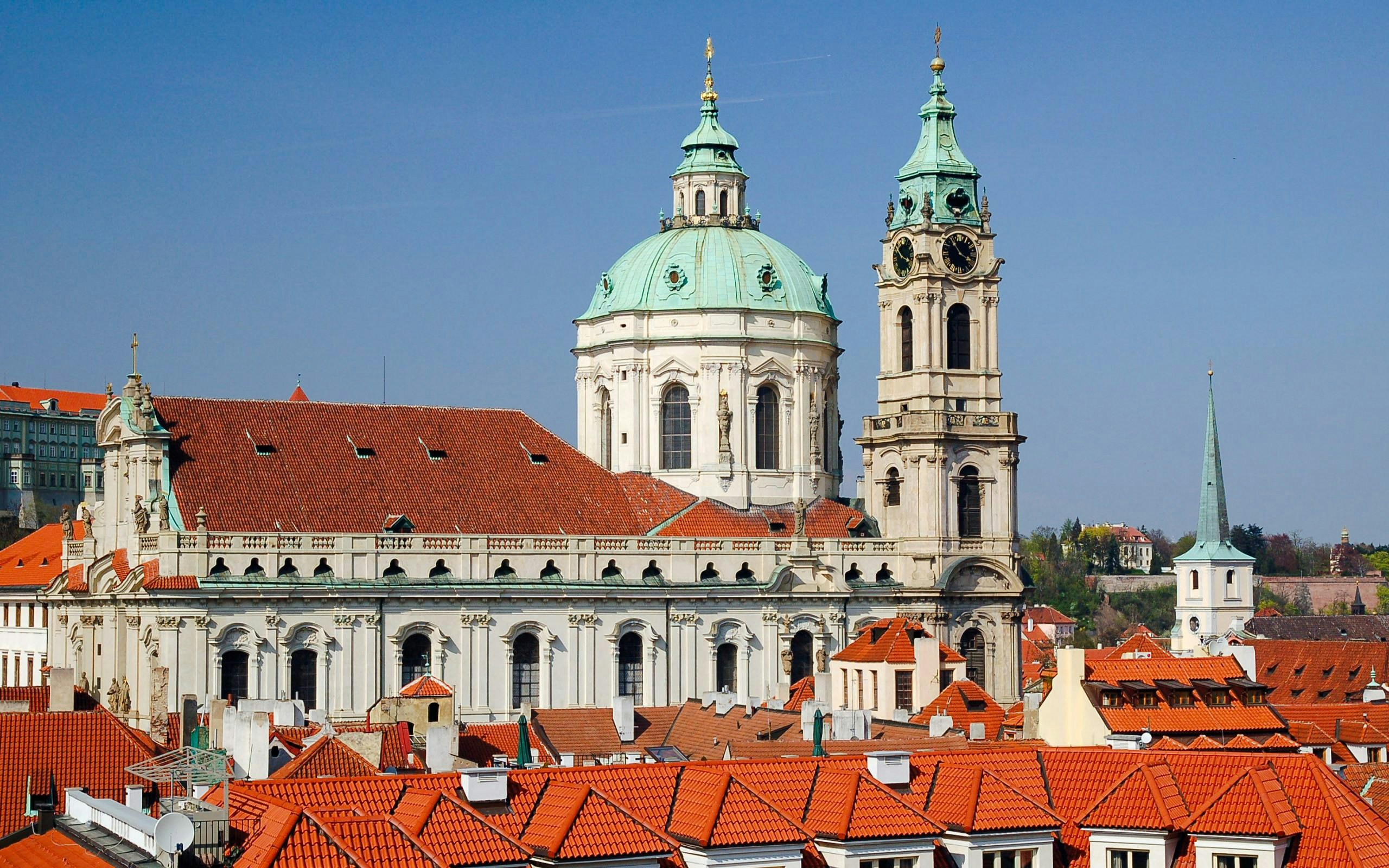 St. Nicholas Bell Tower and church with red rooftops in Prague.