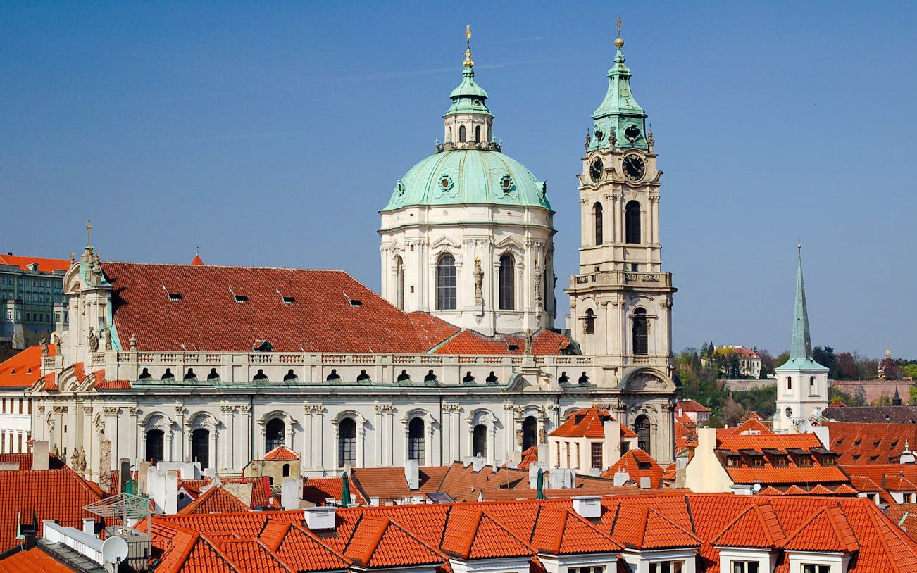 St. Nicholas Bell Tower and church with red rooftops in Prague.