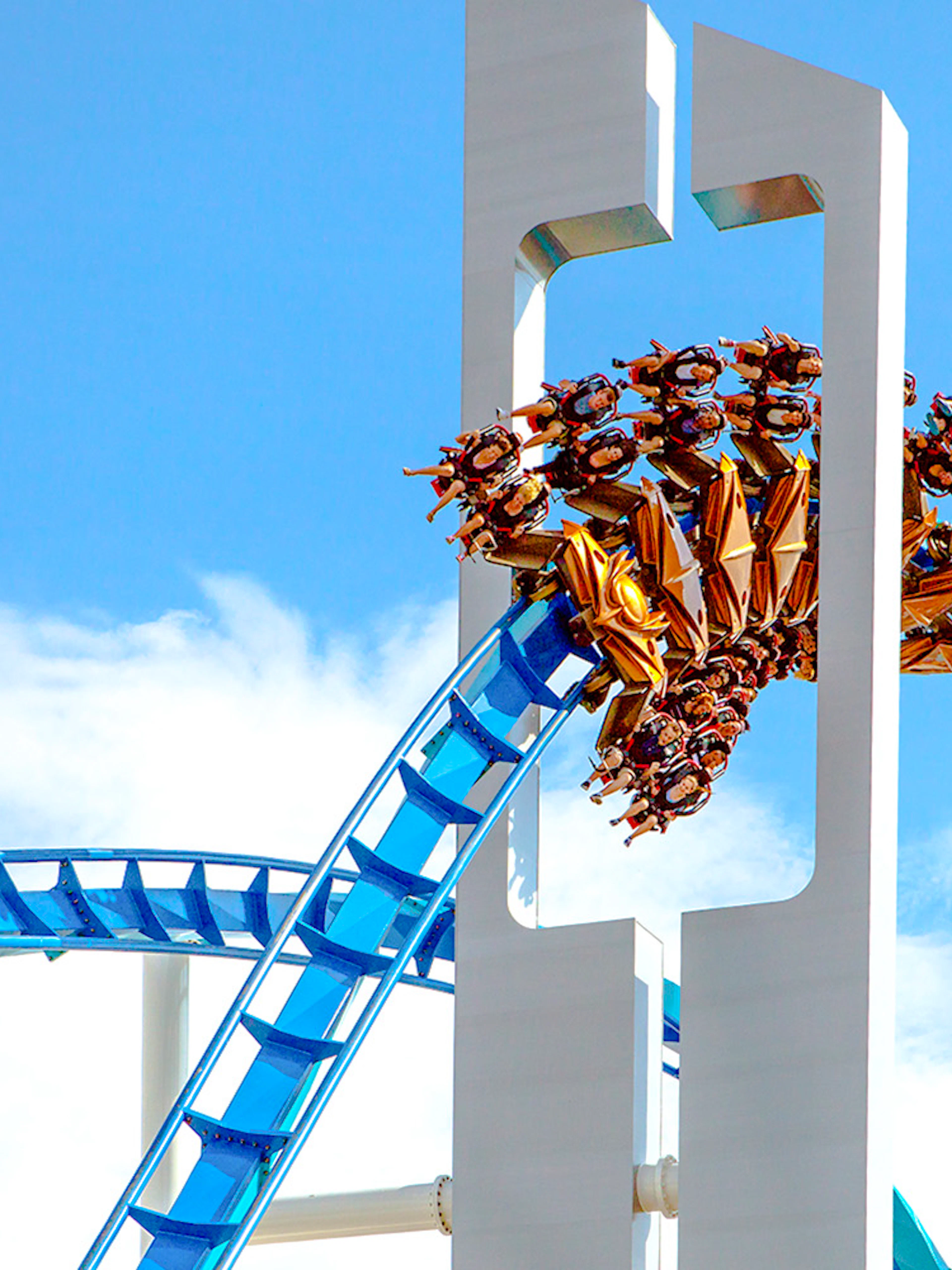 GateKeeper roller coaster looping at Cedar Point against blue sky.