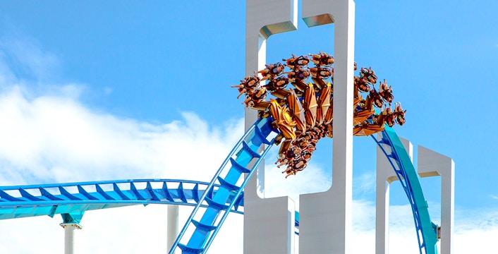 GateKeeper roller coaster looping at Cedar Point against blue sky.