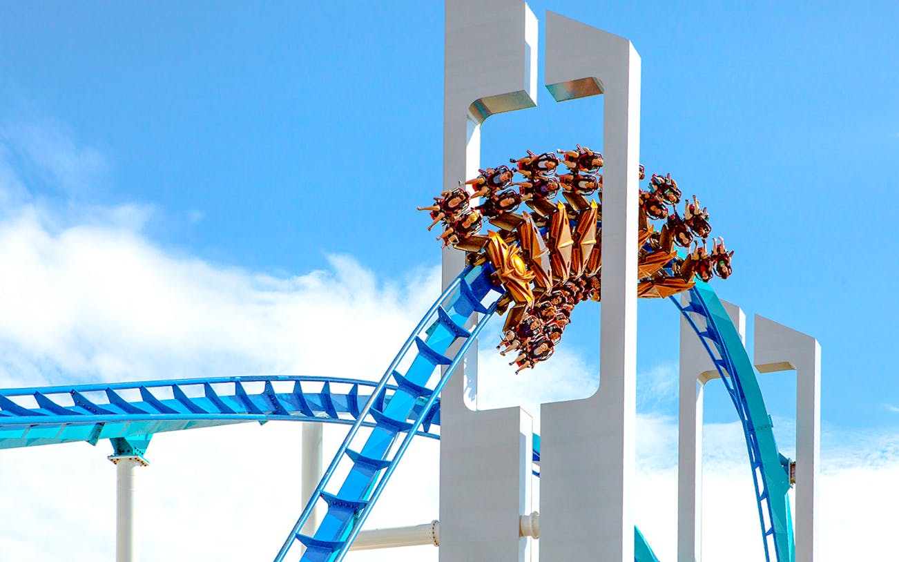 GateKeeper roller coaster looping at Cedar Point against blue sky.