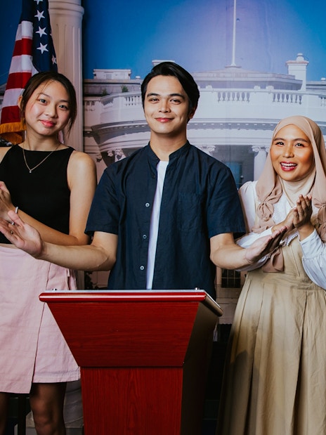 Visitors posing with Obama wax figure at Madame Tussauds Singapore.