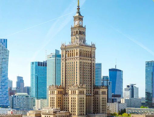 Palace of Culture and Science in Warsaw with surrounding skyscrapers.