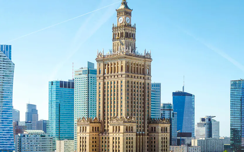Palace of Culture and Science in Warsaw with surrounding skyscrapers.