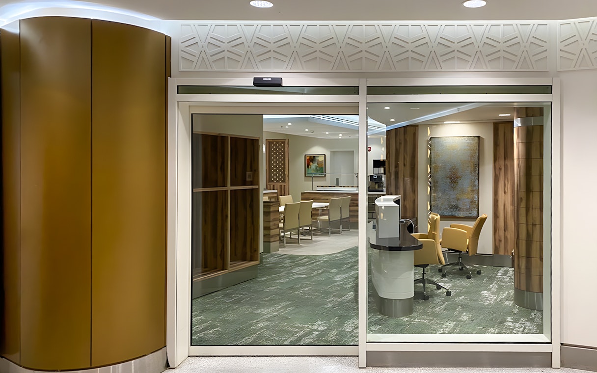 Premium lounge entrance at Jeddah Airport with seating and modern decor.