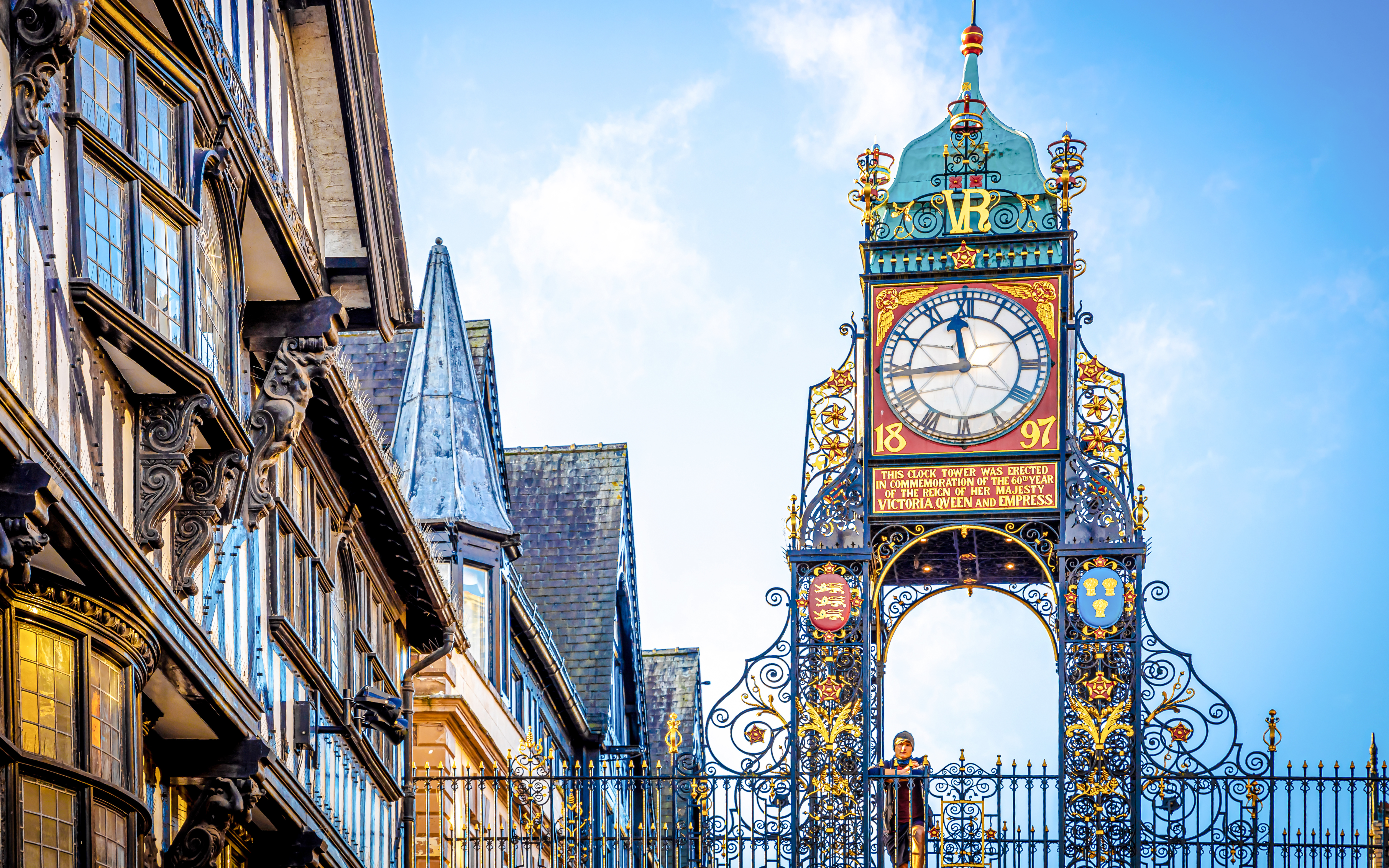 Woman standing on the bridge in front of Eastgate clock of Chester