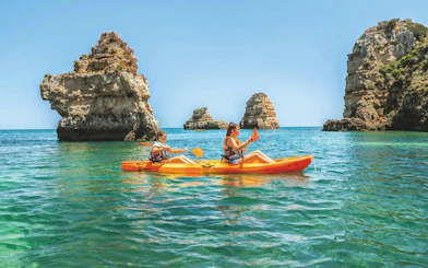 Kayakers exploring rock formations at Ponta da Piedade, Algarve.