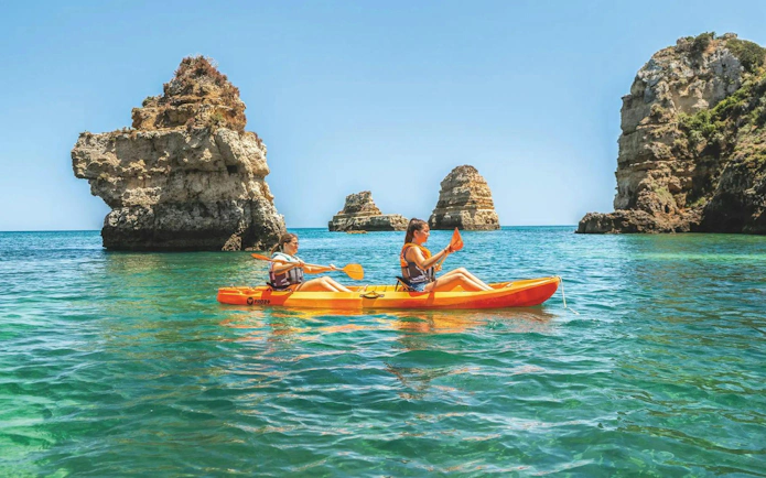 Kayakers exploring rock formations at Ponta da Piedade, Algarve.