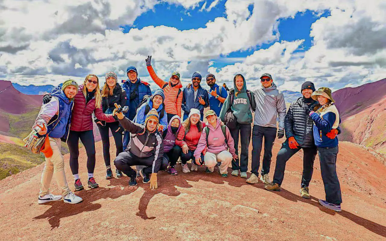 Group of tourists on Rainbow Mountain during ATV tour in Red Valley, Peru.