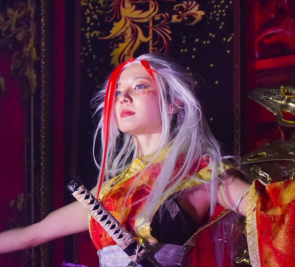 Performer in samurai-themed costume at Samurai Restaurant show.