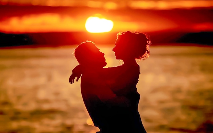 Couple embracing at sunset during Krabi 7 Islands tour.
