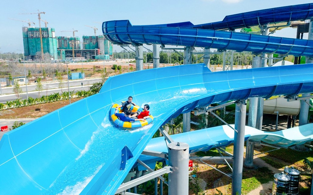 Rafting down a blue water slide at SplashMania Waterpark.