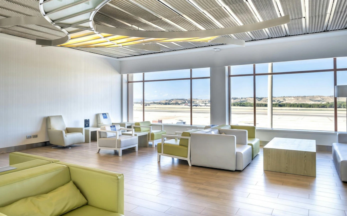 Sala VIP lounge seating area with runway view at Adolfo Suarez-Barajas Airport, Terminal 2, Madrid.