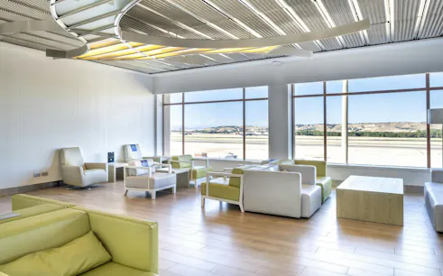 Sala VIP lounge seating area with runway view at Adolfo Suarez-Barajas Airport, Terminal 2, Madrid.