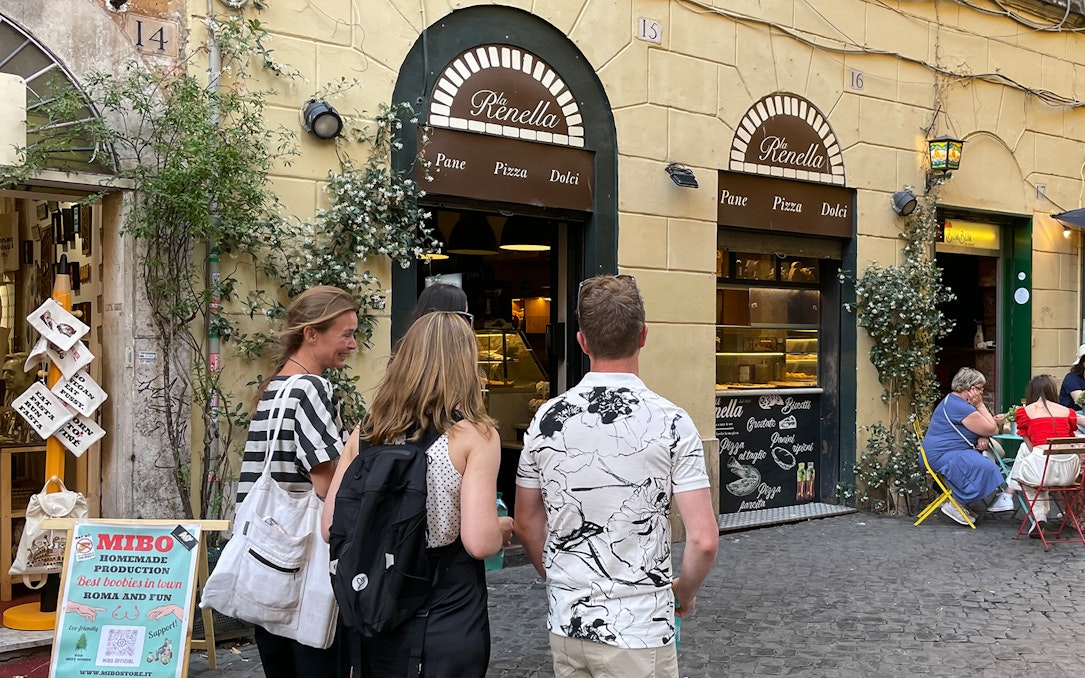 Group of tourists outside a bakery in Trastevere, Rome.