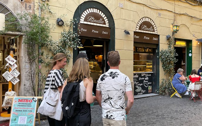 Group of tourists outside a bakery in Trastevere, Rome.