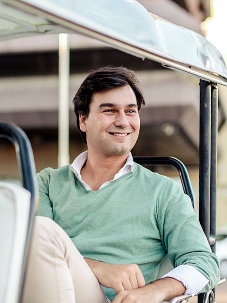 Man enjoying a ride in an Eco Tuk Tuk in a city setting.