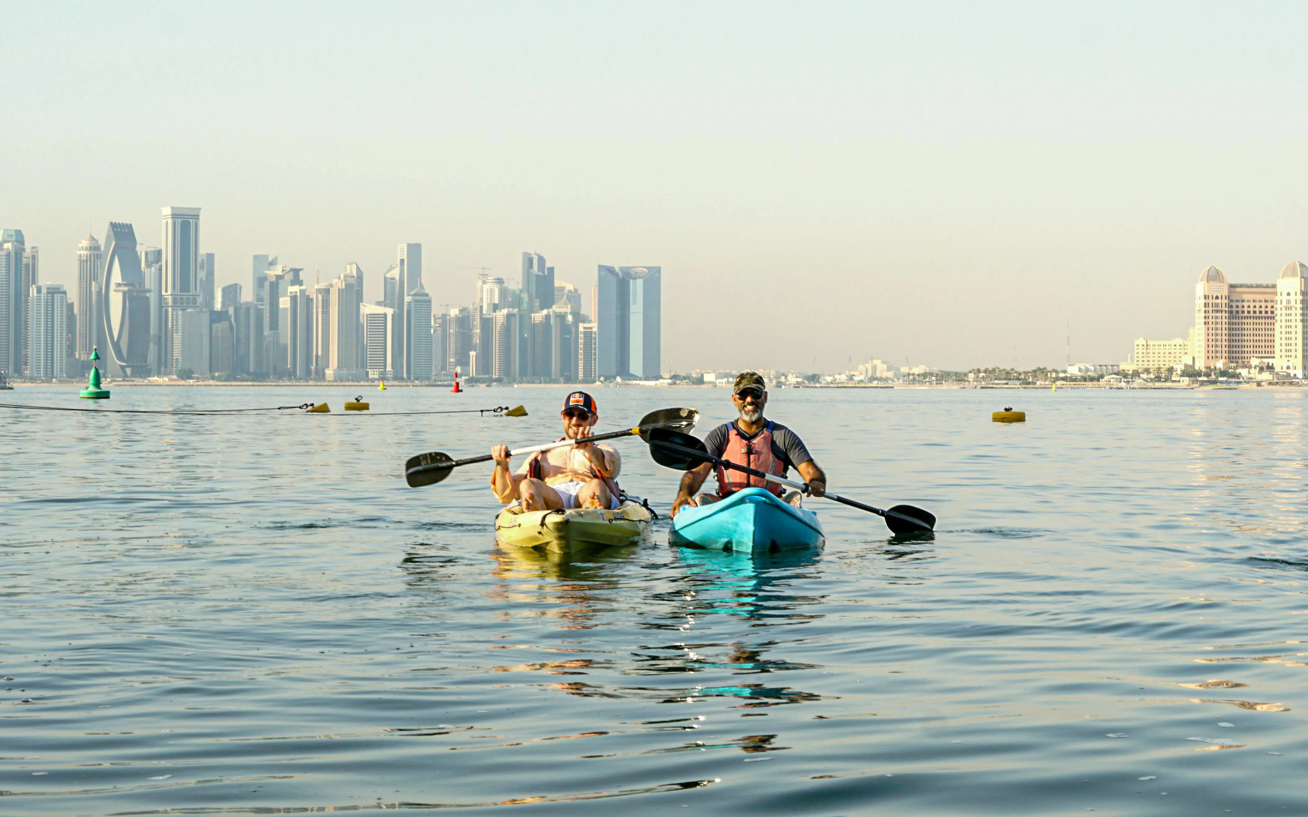 Kayakers on The Pearl Guided Kayak Tour with Doha skyline in the background.