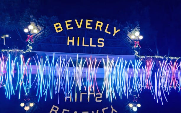 Beverly Hills sign illuminated with holiday lights during Los Angeles tour.