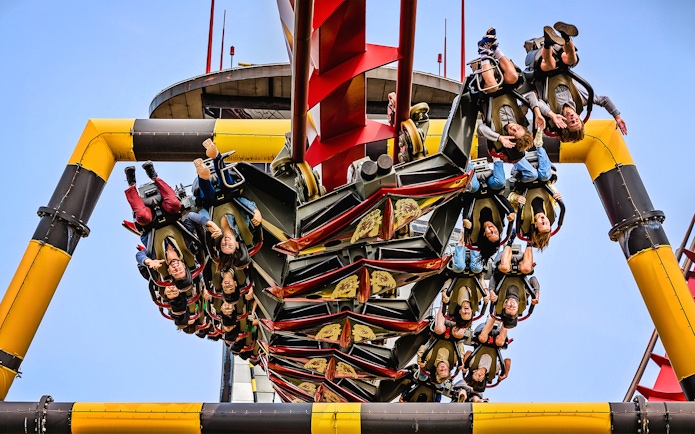 Riders upside down on X Flight roller coaster at Six Flags Great America.