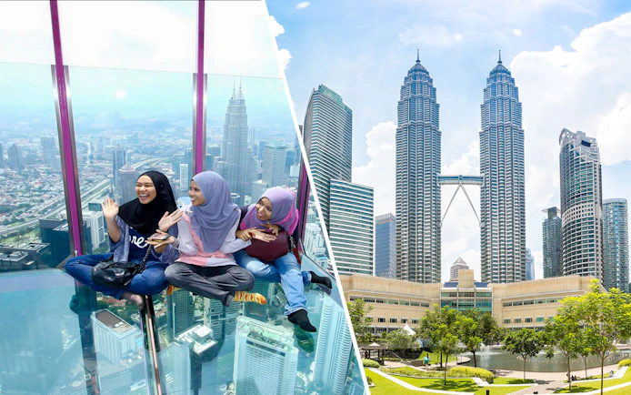 Visitors enjoying the glass sky deck with a view of Kuala Lumpur skyline and Petronas Towers.