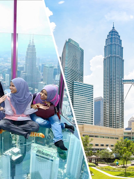 Visitors enjoying the glass sky deck with a view of Kuala Lumpur skyline and Petronas Towers.