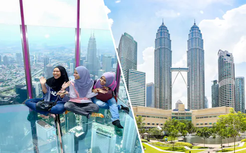 Visitors enjoying the glass sky deck with a view of Kuala Lumpur skyline and Petronas Towers.