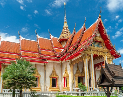 Wat Chalong temple with ornate red and gold roof, Phuket, Thailand.