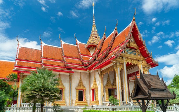 Wat Chalong temple with ornate red and gold roof, Phuket, Thailand.