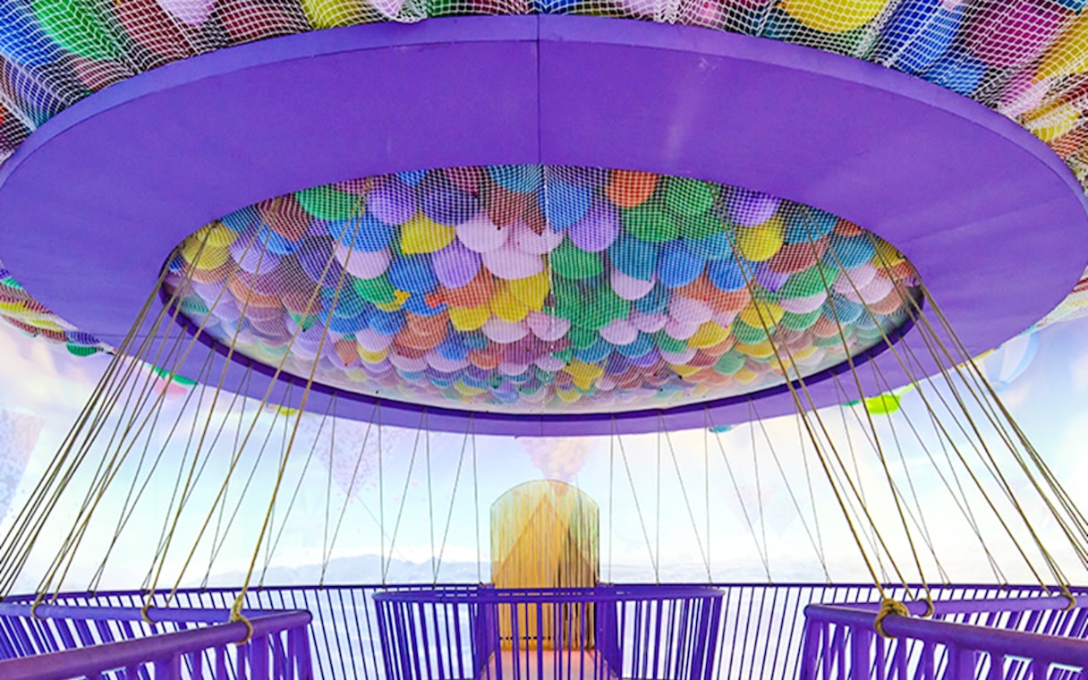Colorful balloons suspended in a net at Bubble Planet An Experience Museum.