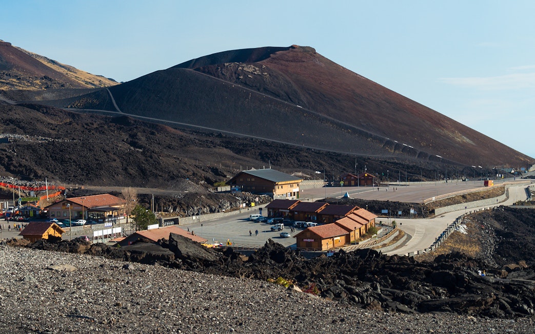Mount Etna with surrounding buildings and road, Sicily, Italy.