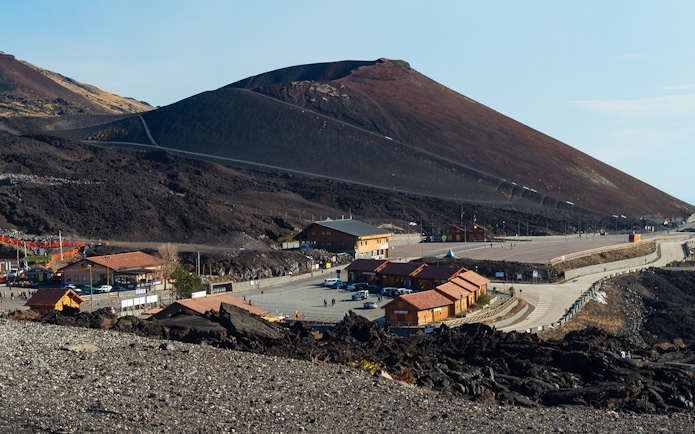 Mount Etna with surrounding buildings and road, Sicily, Italy.
