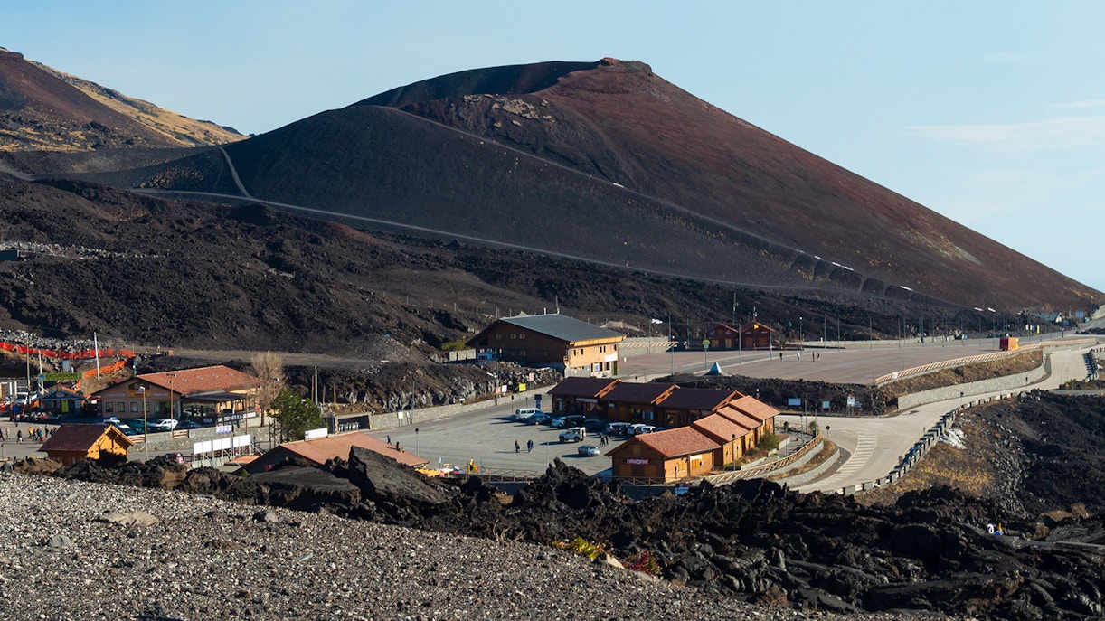 Mount Etna with surrounding buildings and road, Sicily, Italy.