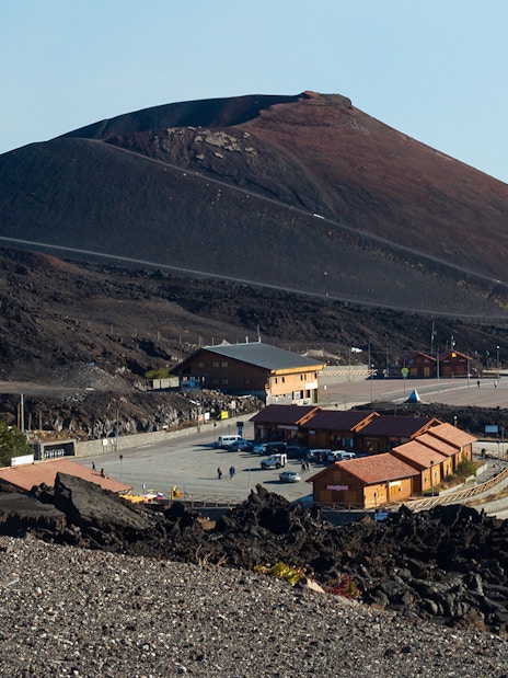 Mount Etna with surrounding buildings and road, Sicily, Italy.