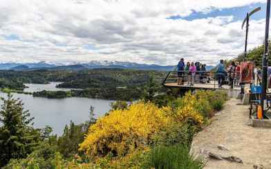 Visitors at a scenic overlook admiring Circuito Chico landscapes in Argentina.