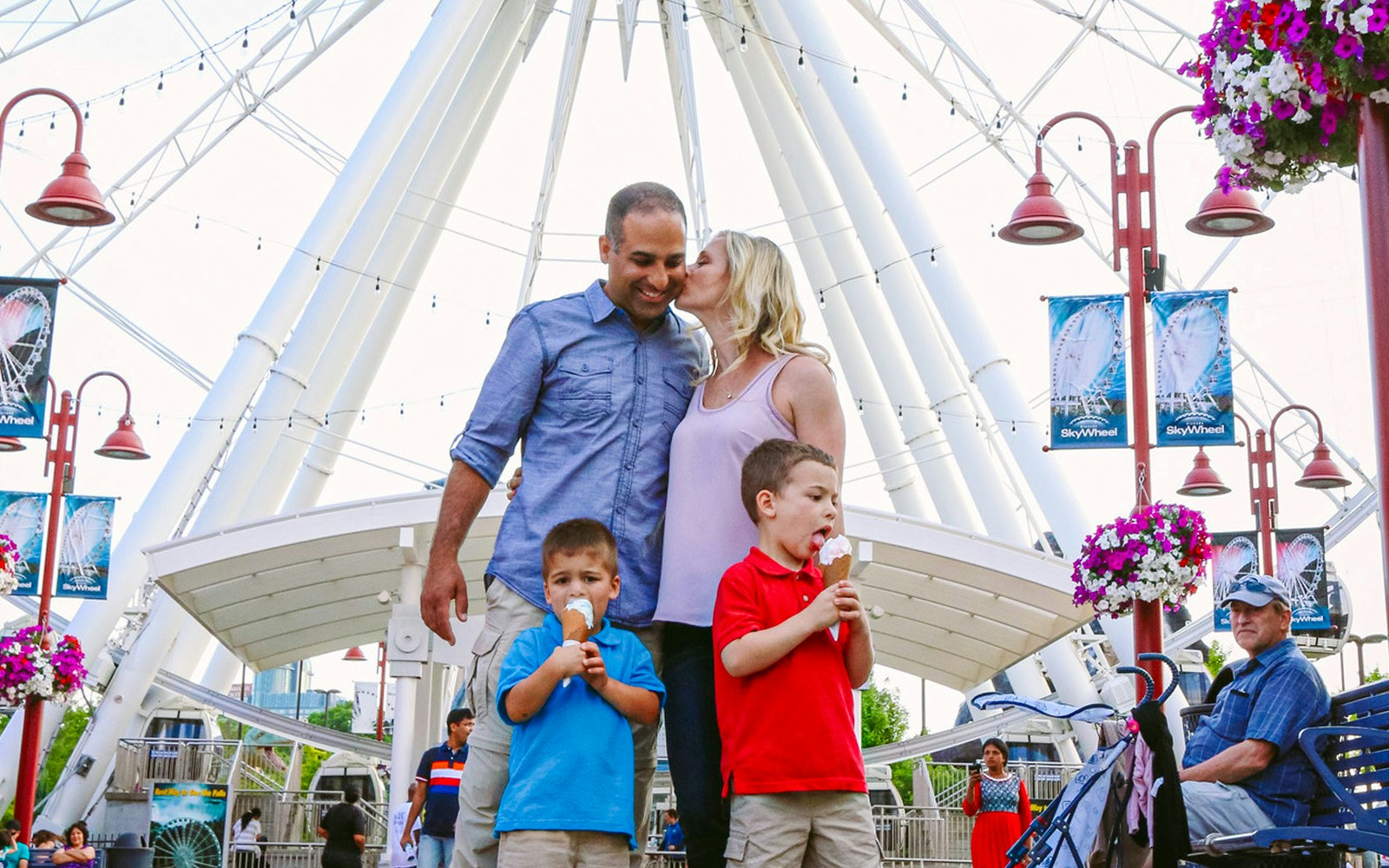 Family enjoying ice cream in front of Niagara SkyWheel, Canada.
