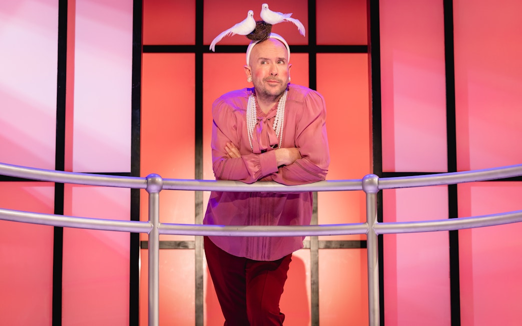 Stage performer in Titanique Westend with doves on headpiece.